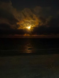 View of a nearly full moon taken through the living room window.