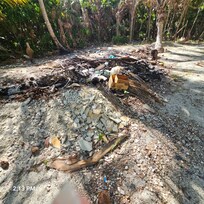 Garbage/ burn pile in front of buildings