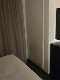 Exhaust vent oder and noisy loud compressor in the rooms hidden behind this wall at foot of bed