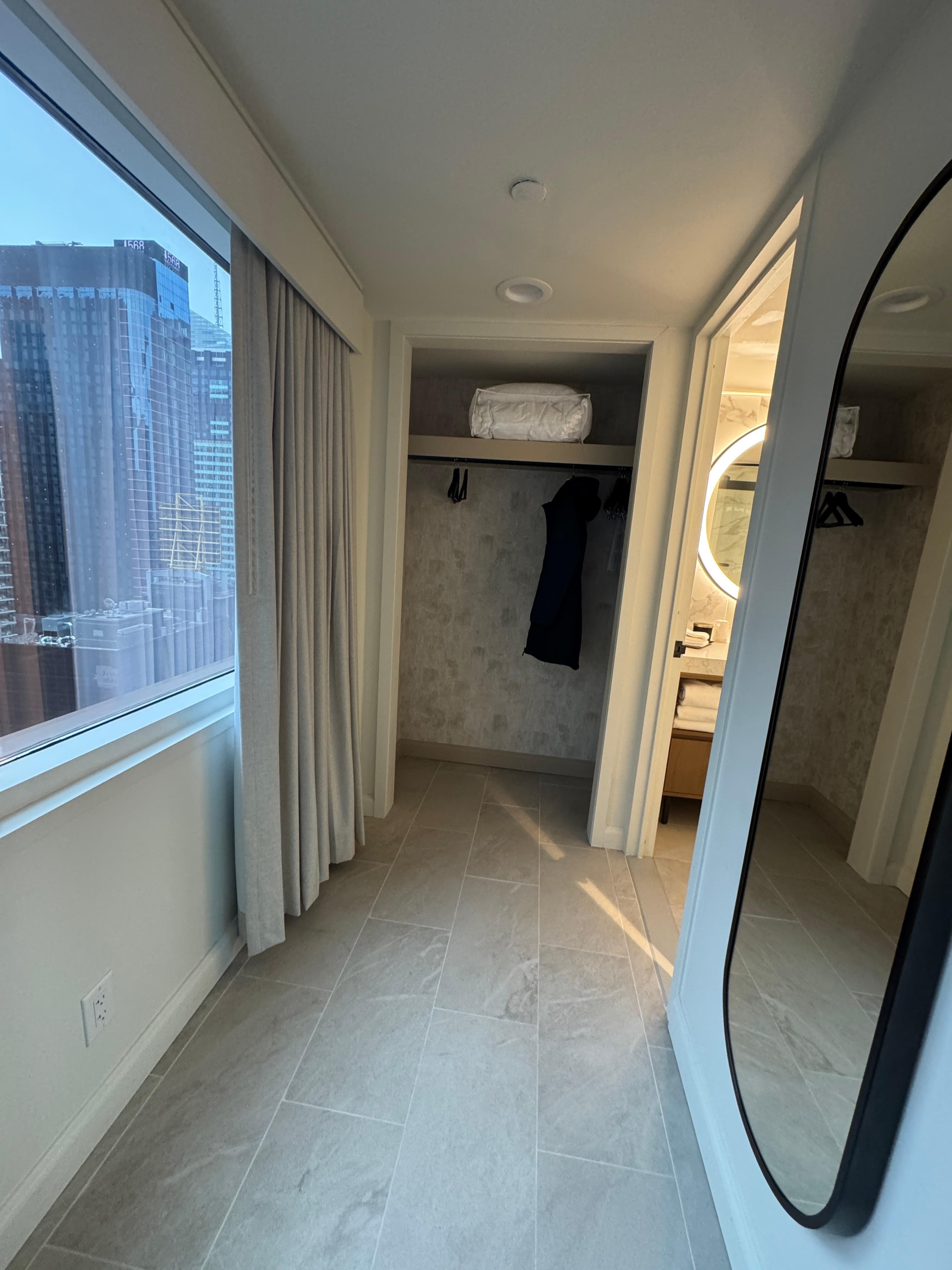 Hallway to bathroom with full length mirror