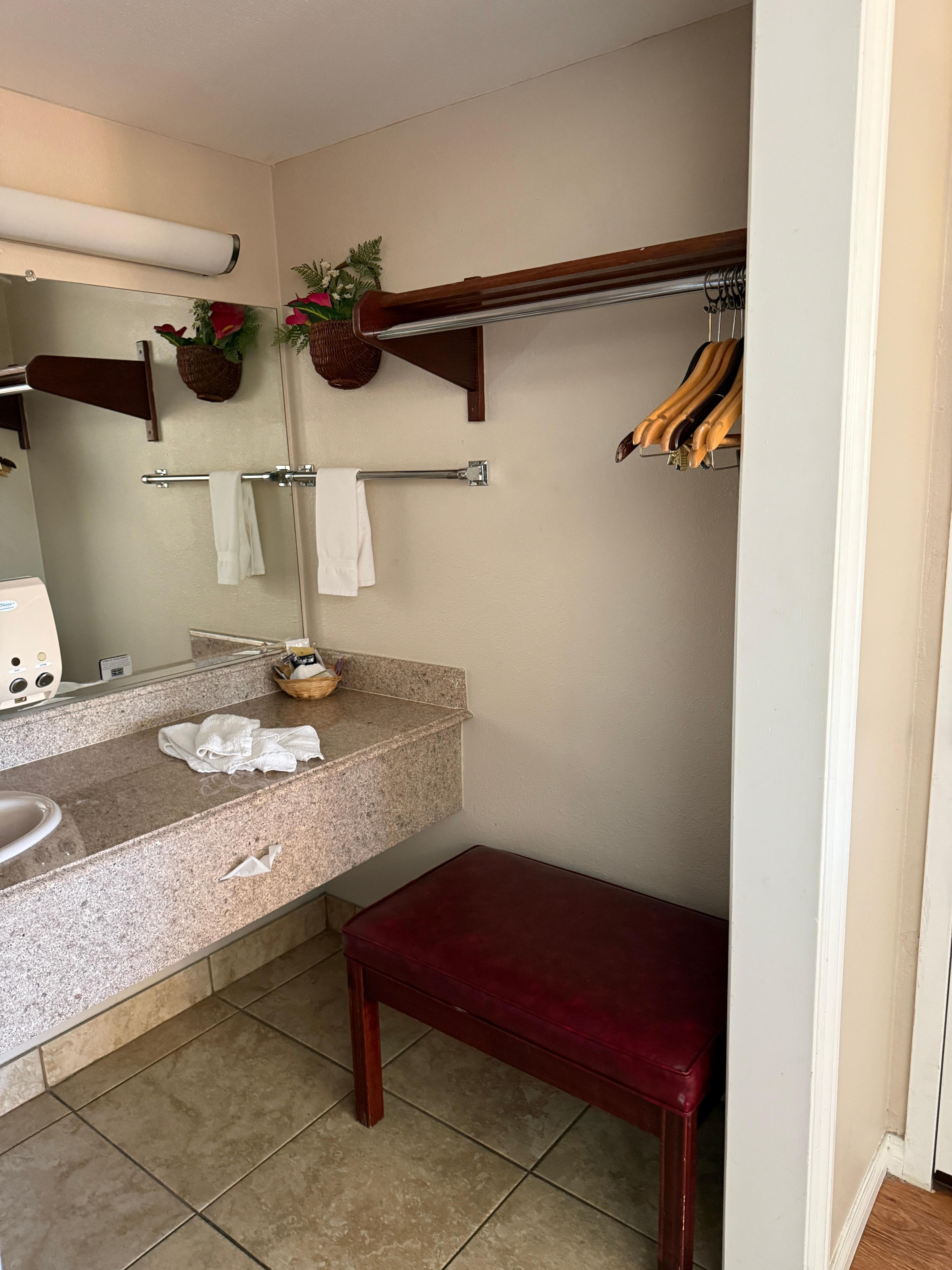 Alcove for suitcase and hanging clothes.