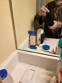 plug cover taped to bath mirror