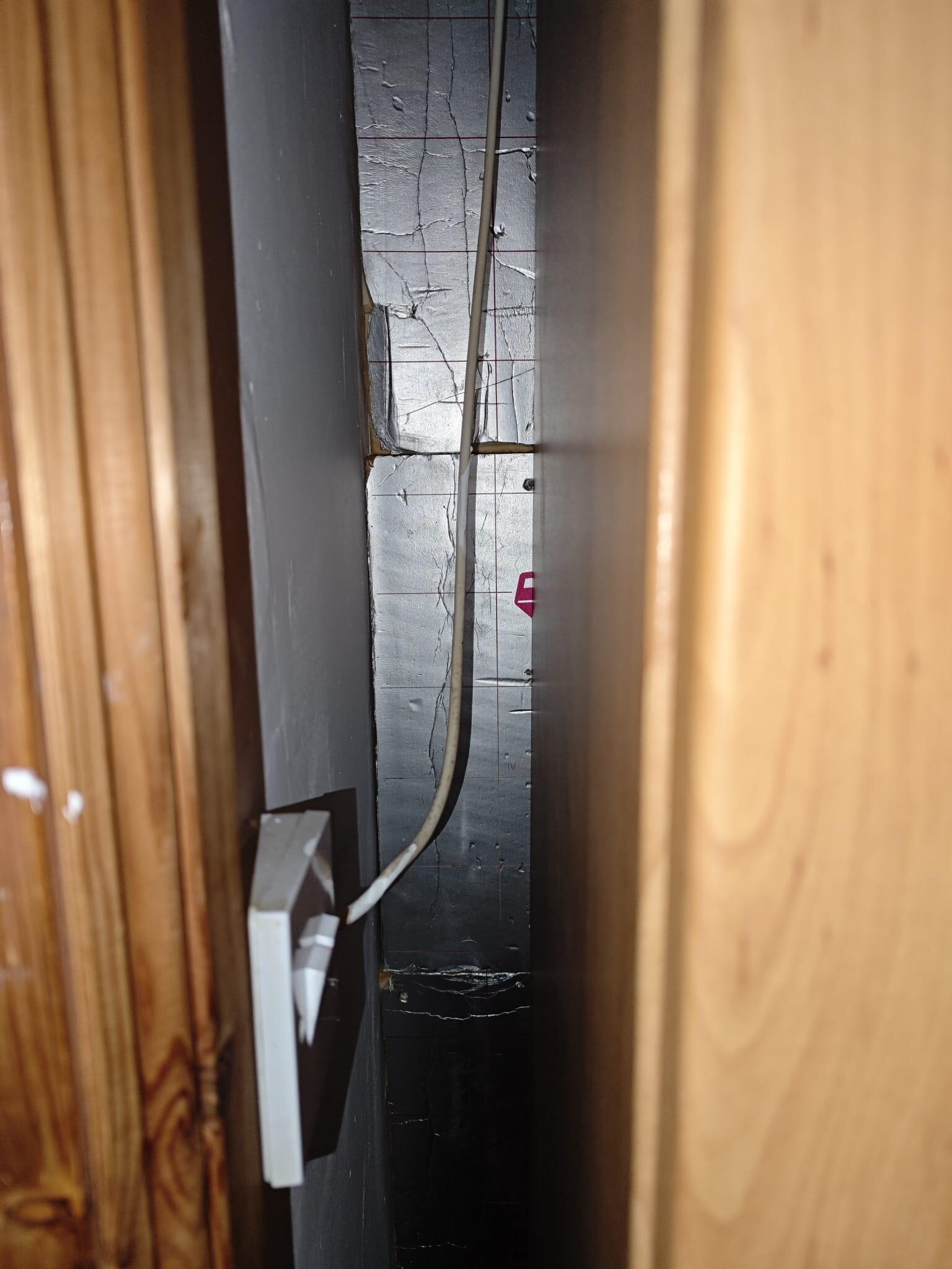 Exposed Celotex insulation boards in bedroom