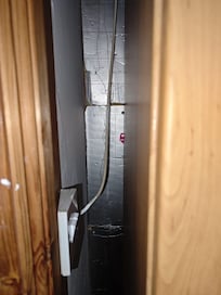 Exposed Celotex insulation boards in bedroom