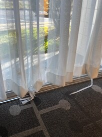 Stained ripped curtains in room