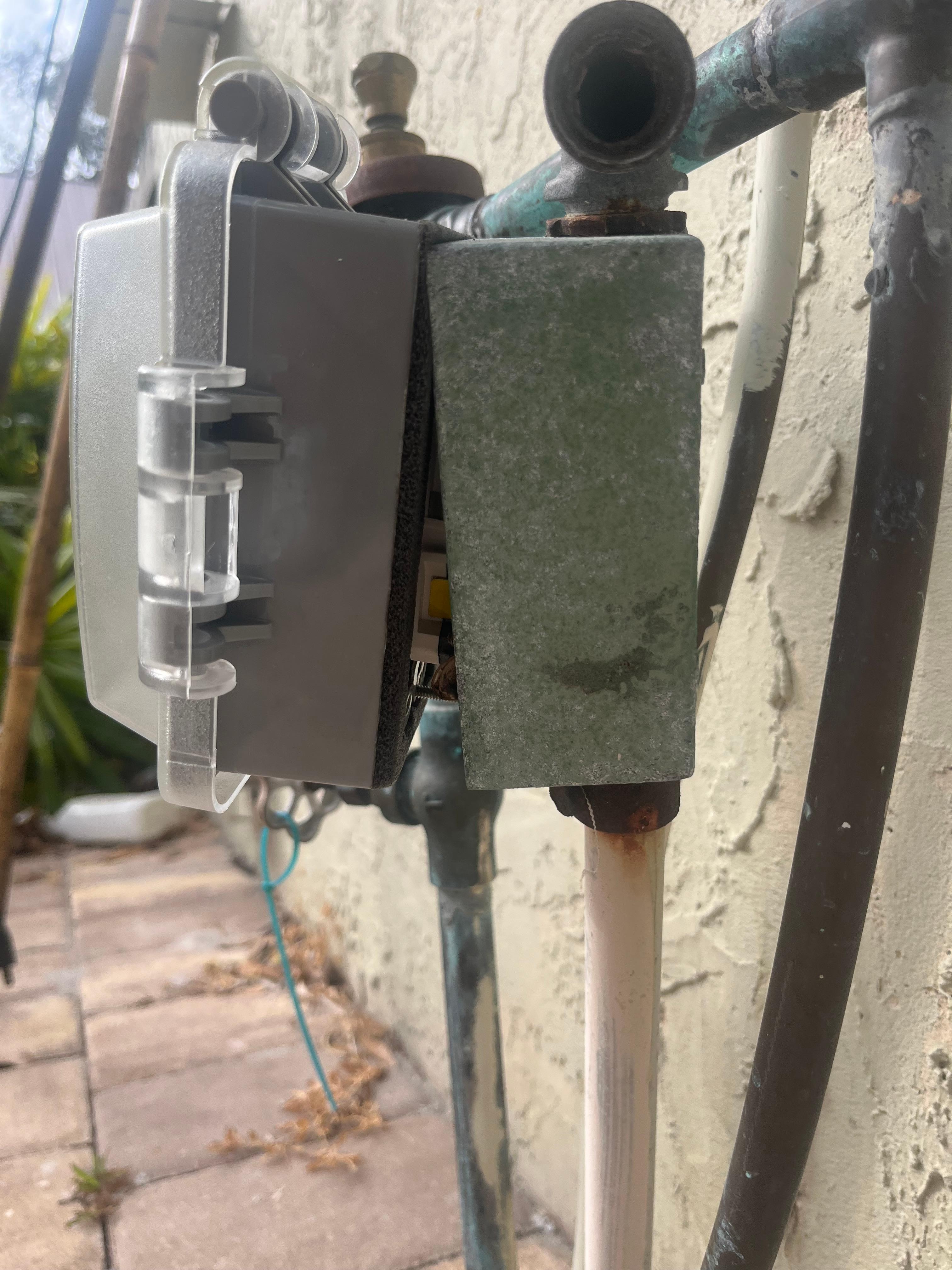 Exterior electrical boxes cracked open exposing wires.