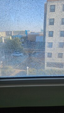 5th floor window shattered. Looks like a bullet hole