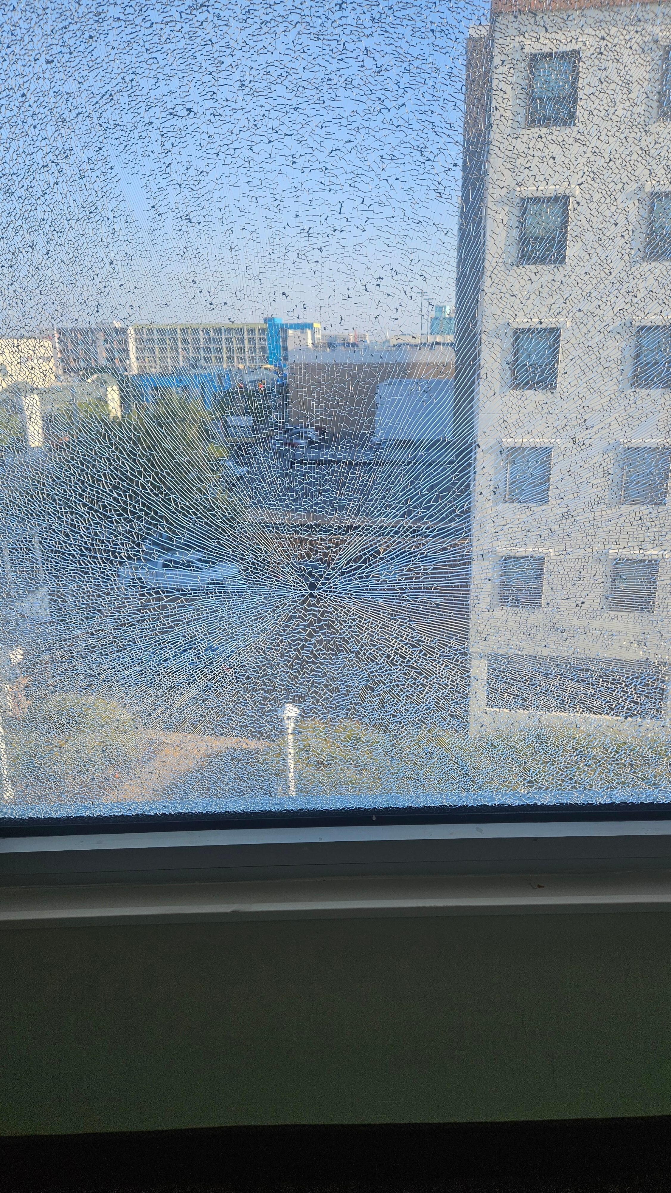 5th floor window shattered. Looks like a bullet hole 