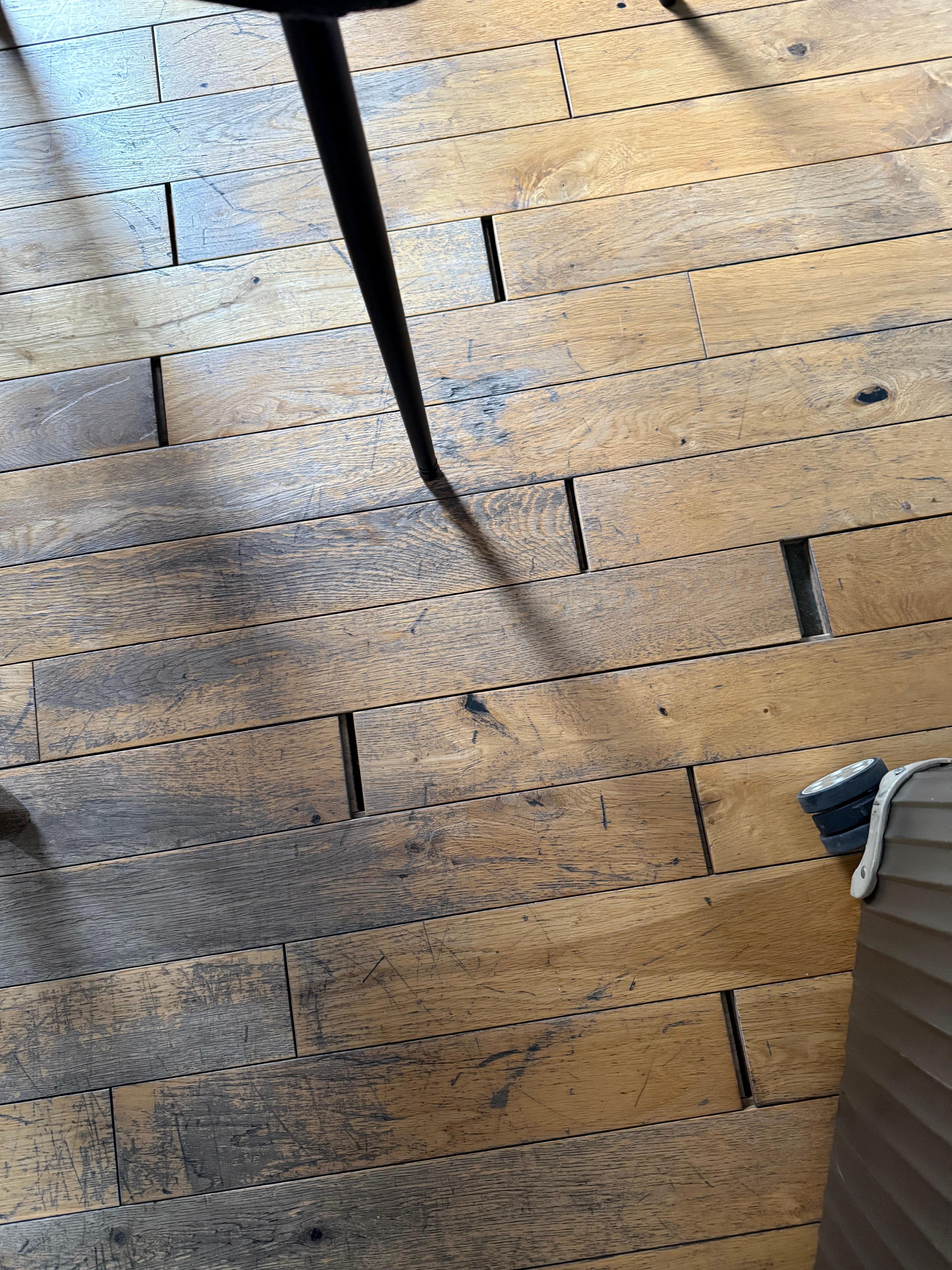 Worn floorboards that no longer meet.