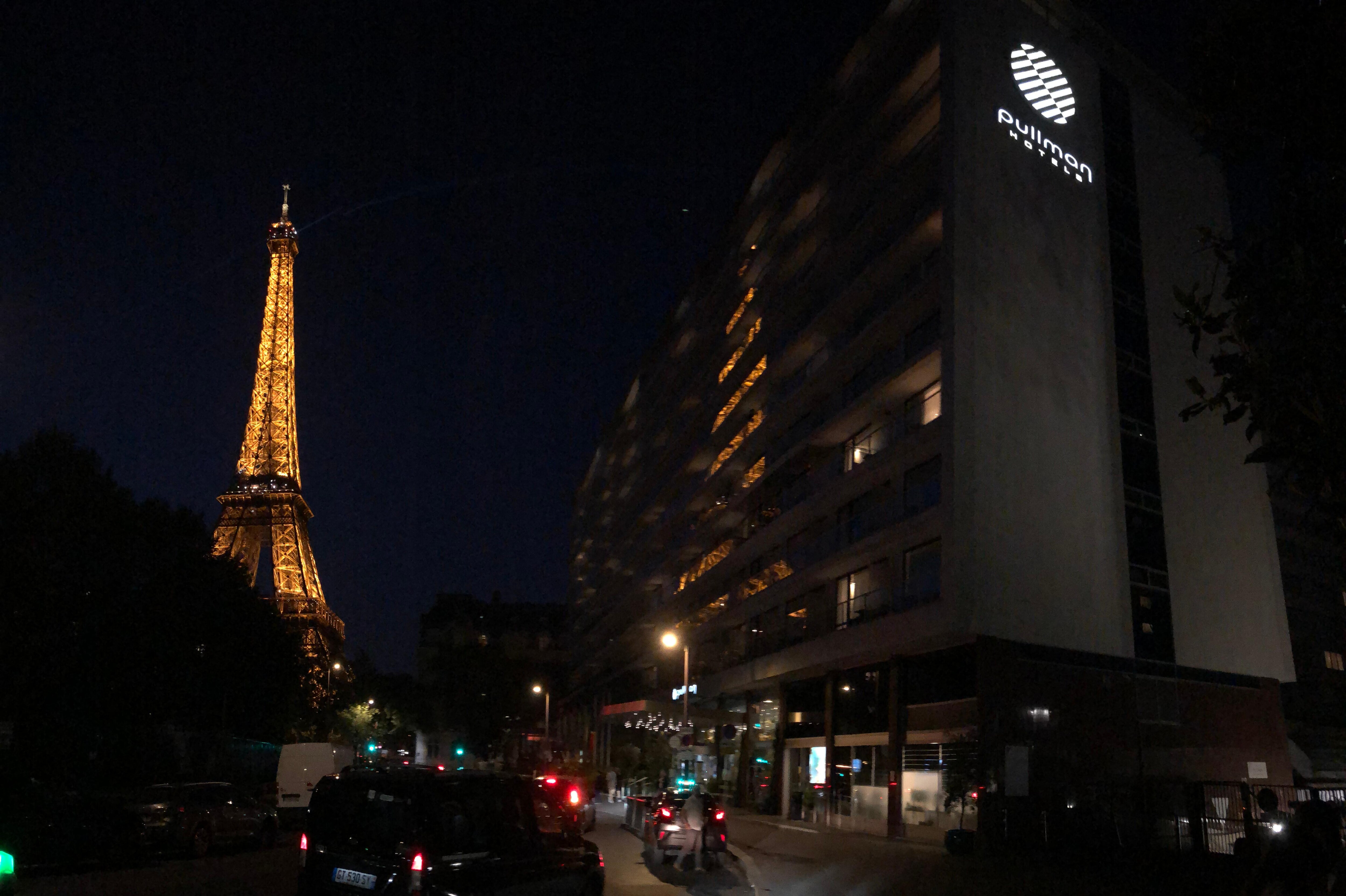 Exterior view of hotel and Eiffel Tower from down the street near hotel 