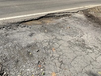 Pot hole at street entrance to driveway