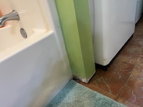Missing baseboard - tub not very clean