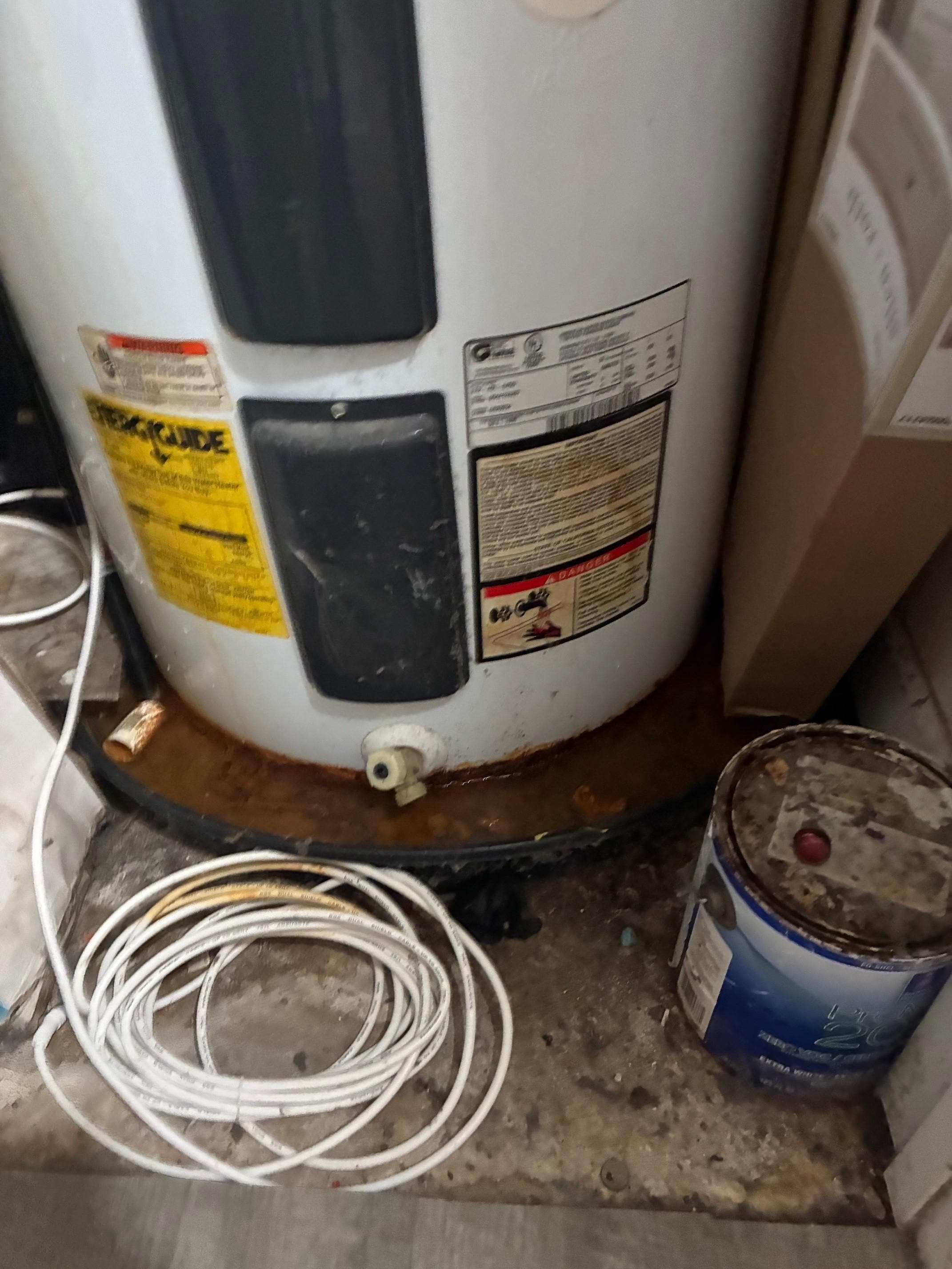 Stagnant rust water under hot water tank.In the condo closet. There was a humid and moldy odor in the condo.