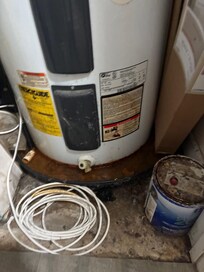 Stagnant rust water under hot water tank.In the condo closet. There was a humid and moldy odor in the condo.