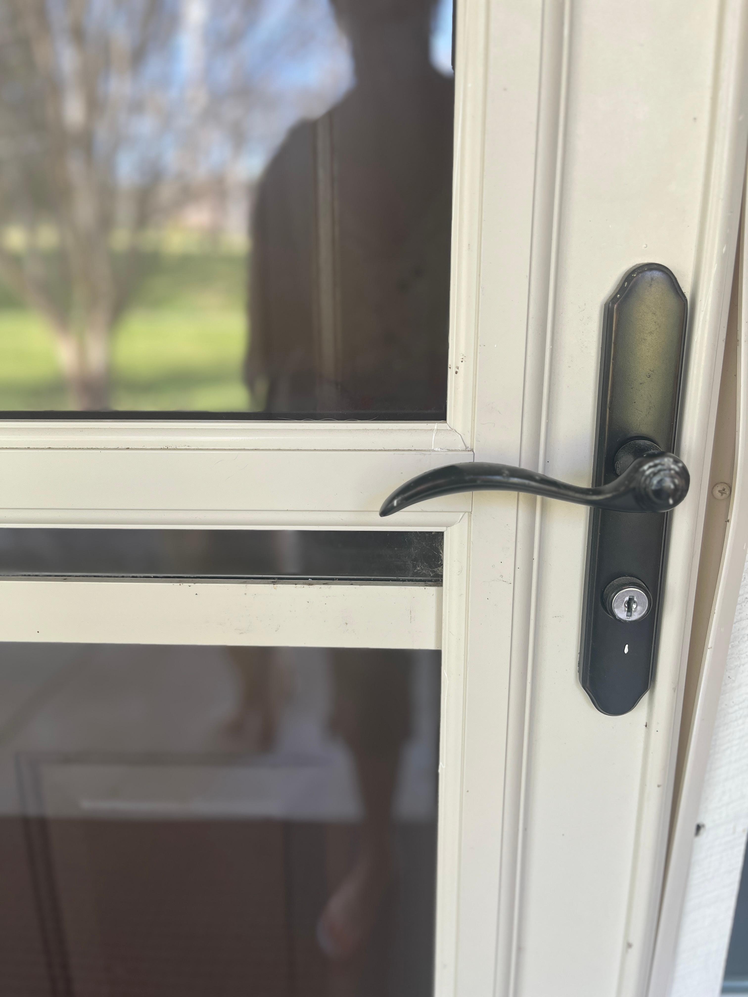 The storm door obscures the keypad on the door