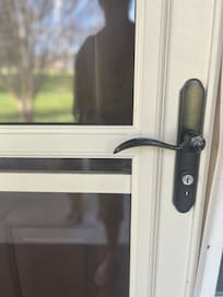 The storm door obscures the keypad on the door