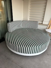 Very comfy circular sofas on poolside patio rooms.