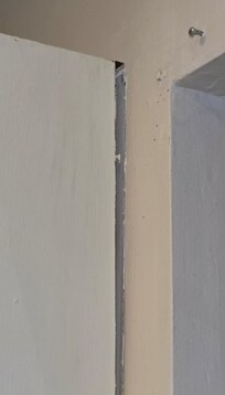 Kitchen cabinet falling off wall closeup