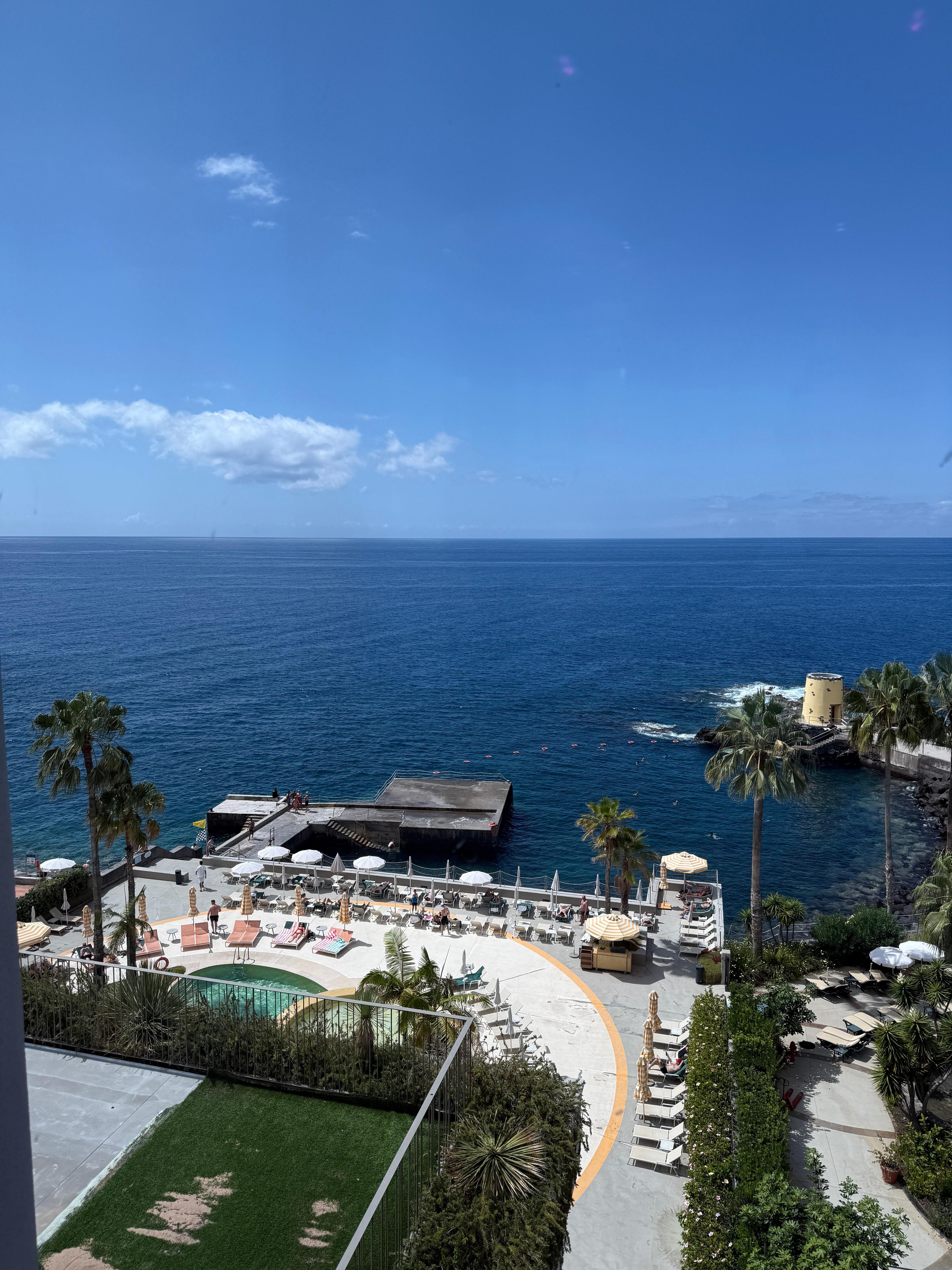 View of the pool area and the pier at the sea