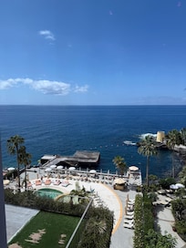 View of the pool area and the pier at the sea