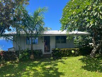 The front of the cottage facing the road.