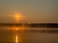 The sun breaking up the fog while out casting