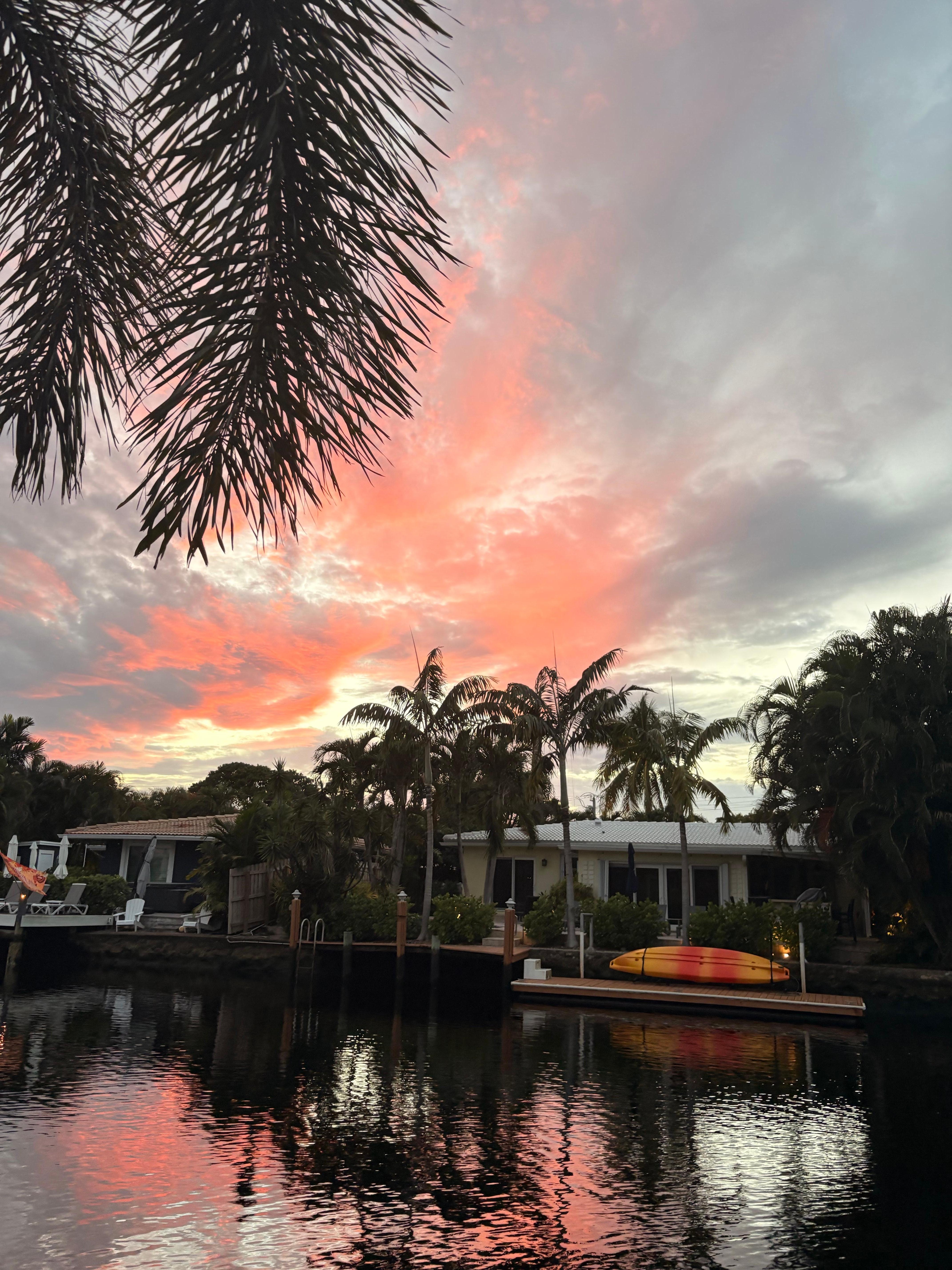 View from the pool, looking out onto the canal at sunset.