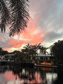 View from the pool, looking out onto the canal at sunset.