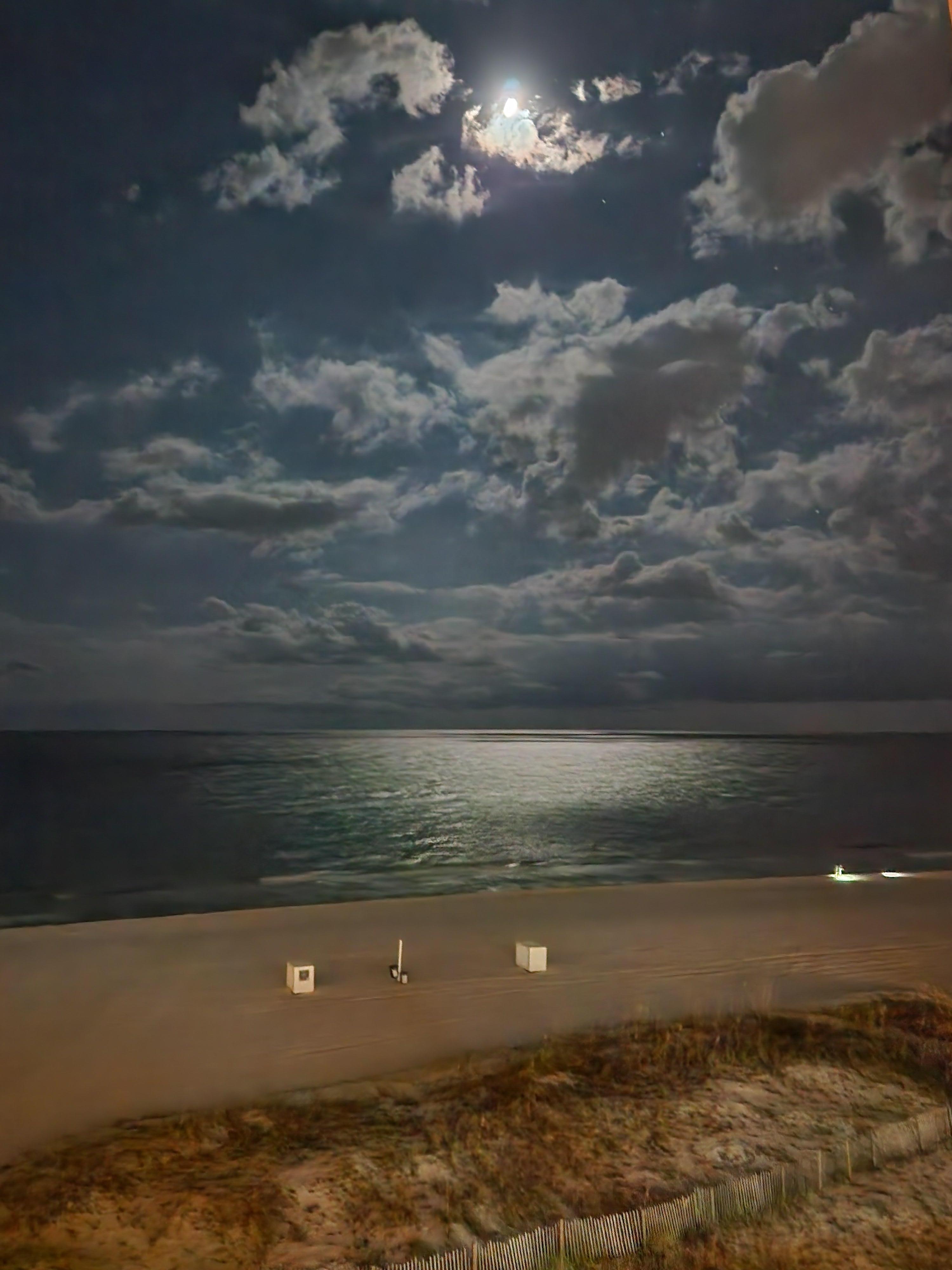 Moonlit beach view from balcony.