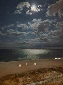 Moonlit beach view from balcony.