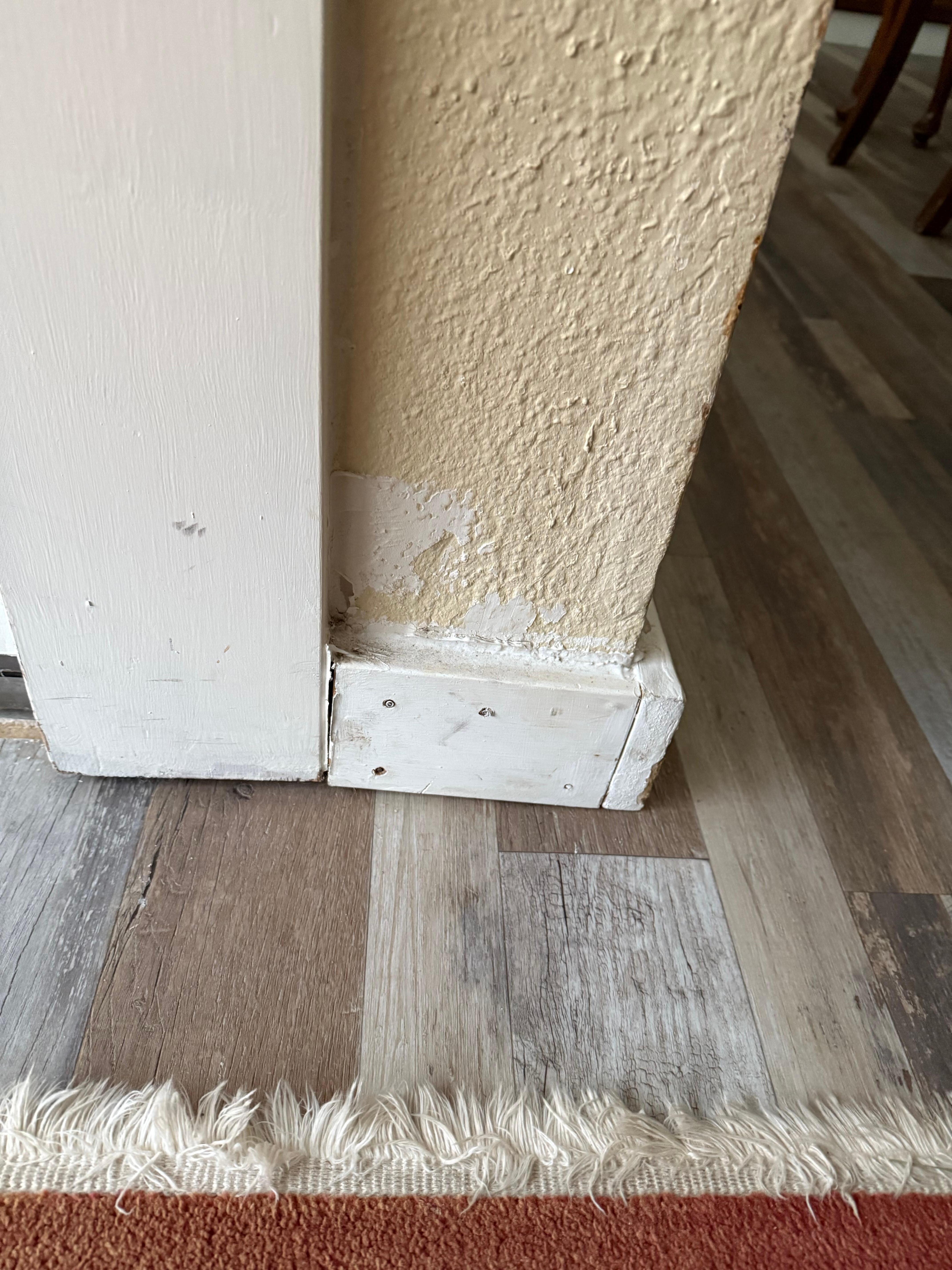 Wall not painted above poorly installed baseboard 