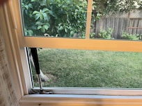 Window propped up with  hammer
