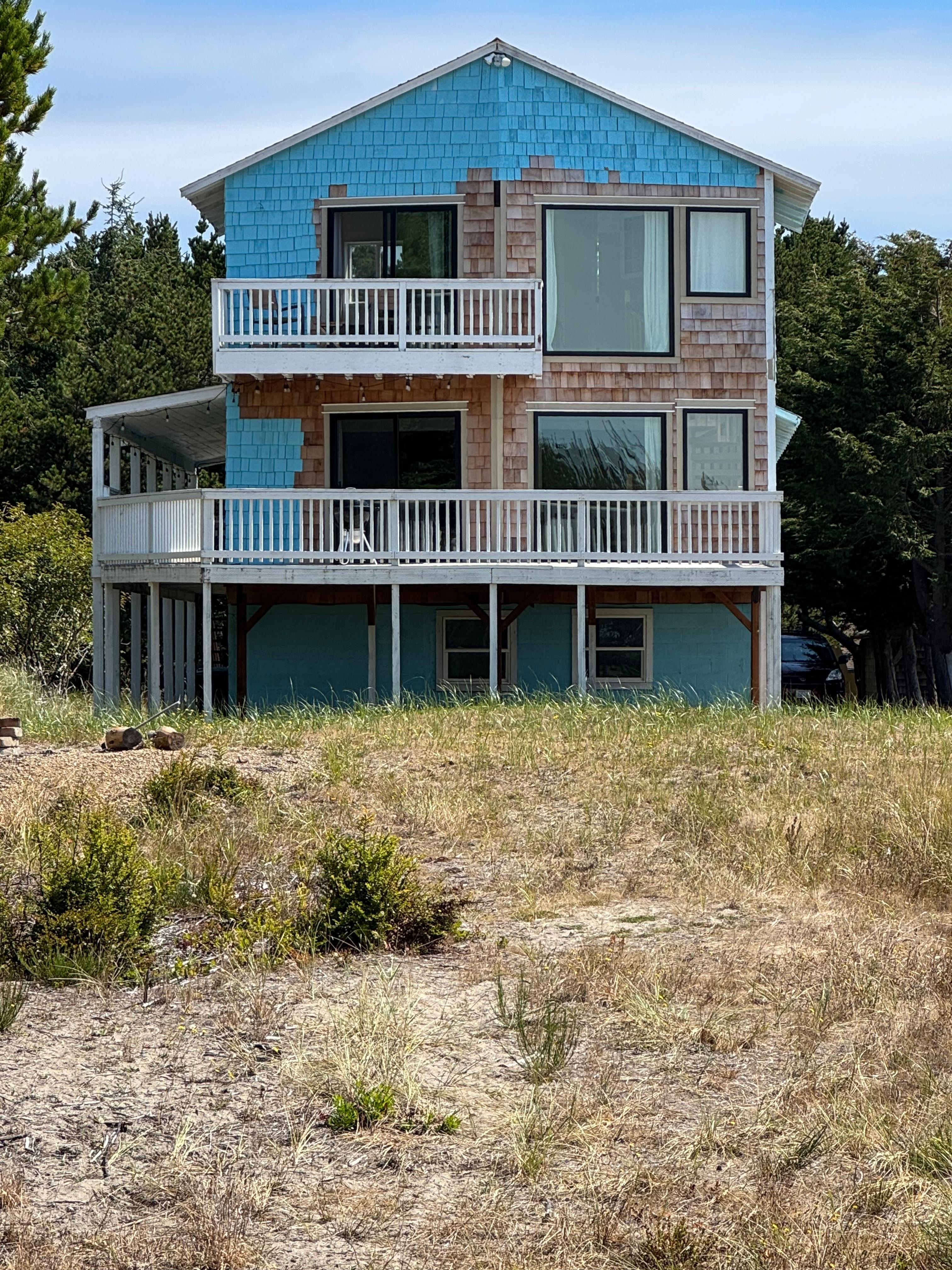 The house coming back form the beach, you can see lots of yet to be painted siding from this side.  Perhaps replacing windows and/or dry rot, but not quite finished.