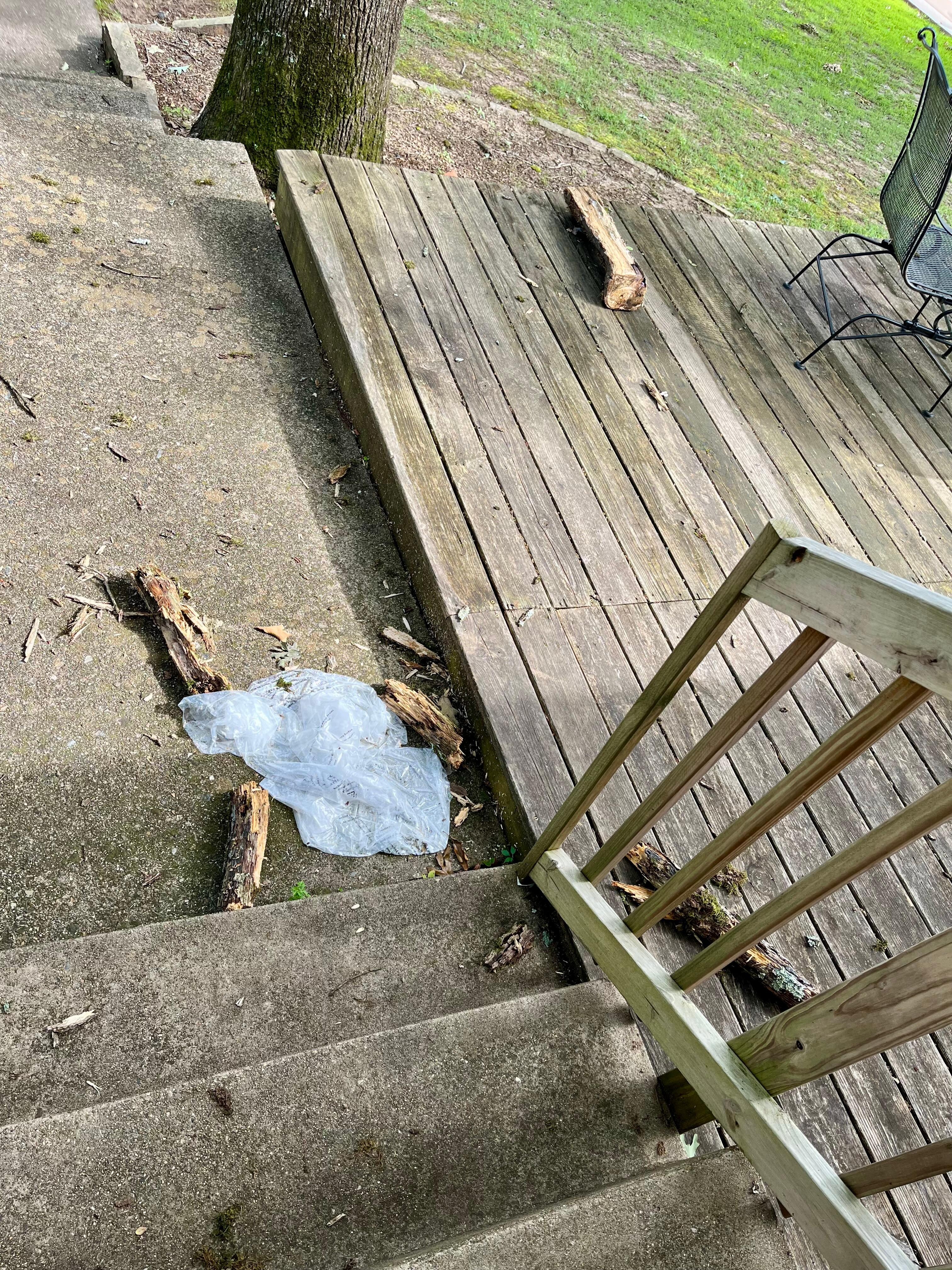 Trash and debris on the patio. Also, deflated water toys in a pile on the deck. No one came to clear the debris.