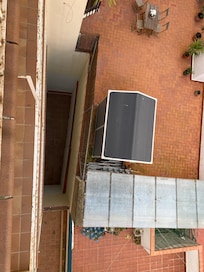 Below is the two story deep hole in the ground where the unit 00 faces. Taken from the 4th floor. There is no other frontage.