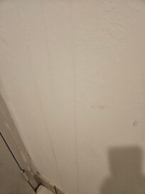 Leaks down wall from above.