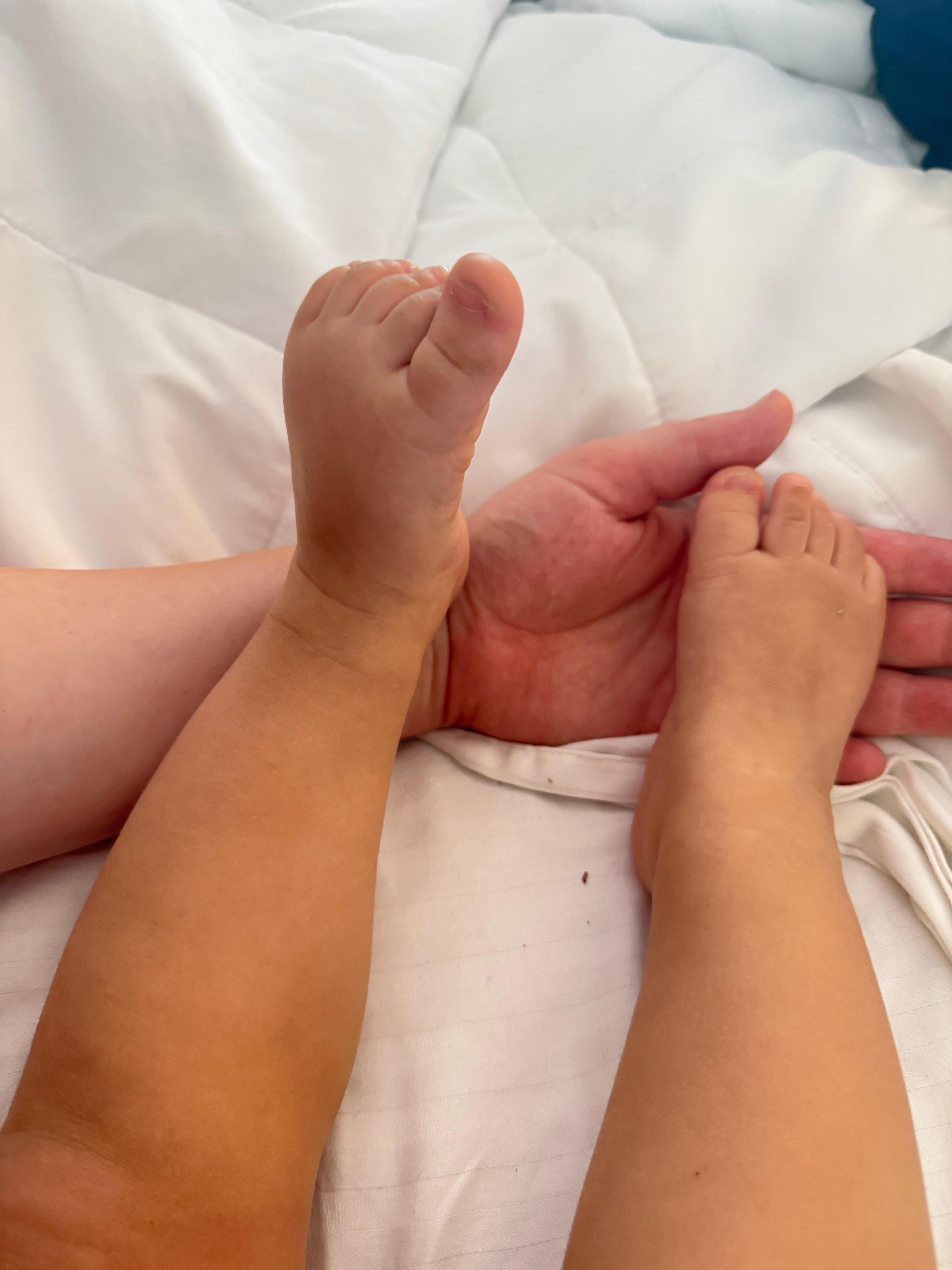 Dirty baby feet from crawling on the floor.