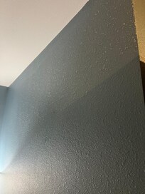 Thick dust on wall in the bedroom.