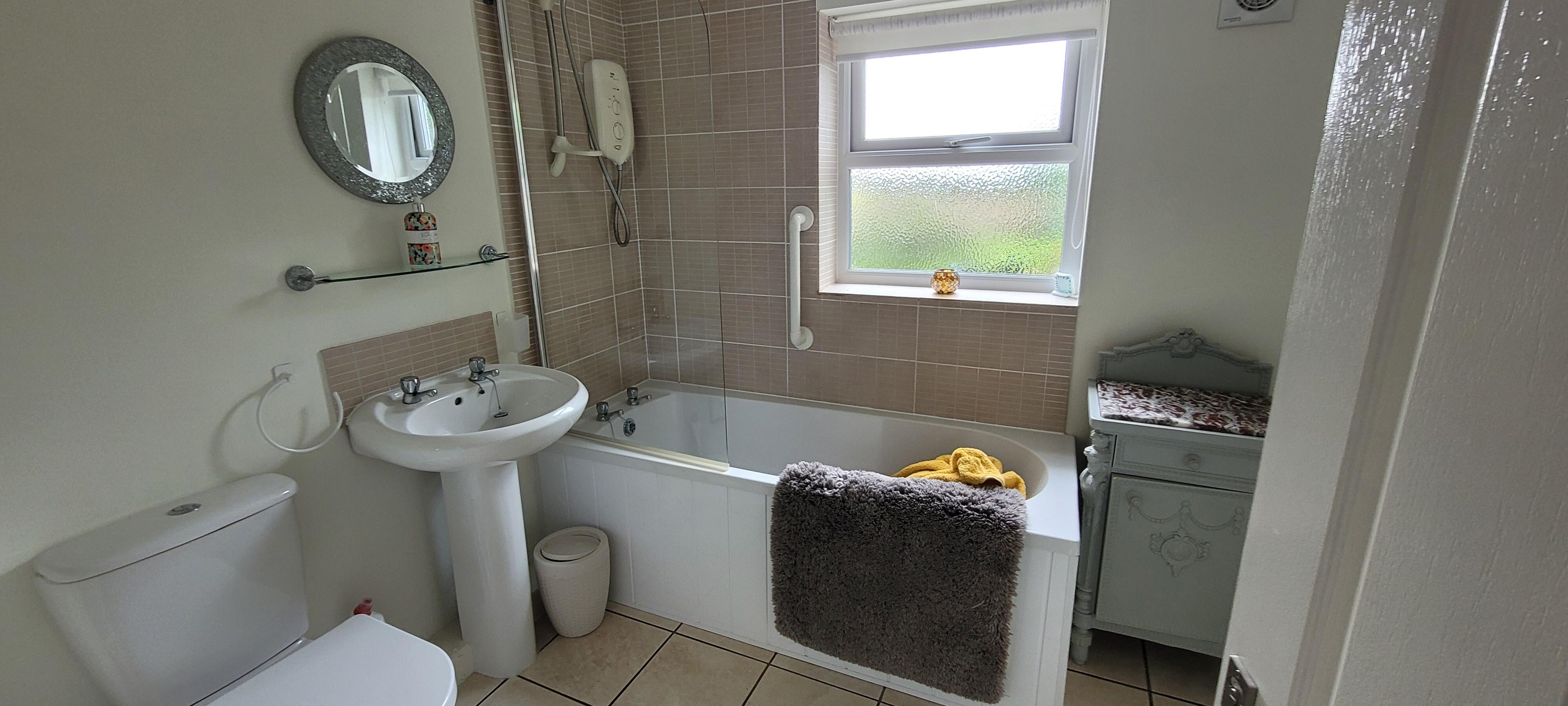 Large bathroom with towel heater and blow heater.