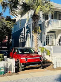 Front of the house. Don’t forget to park in the driveway or you’ll get a polite parking violation for parking in the golf cart area :)