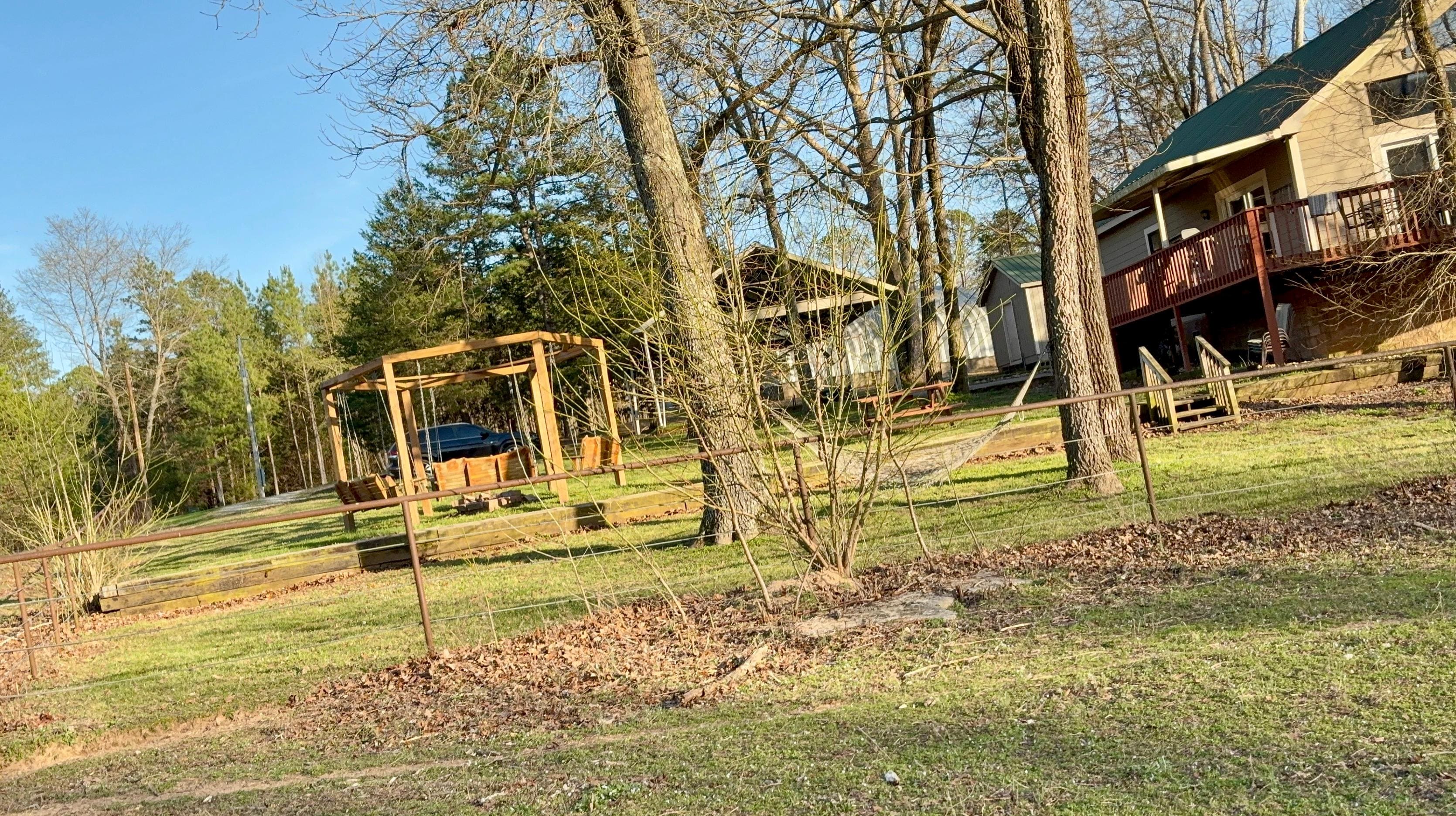 House view & swing-firepit rotunda from the entry of the river path.