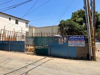 Garage demolition site from rear alley, not side service alley.