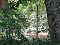 View to the flowing river from the lawn area.