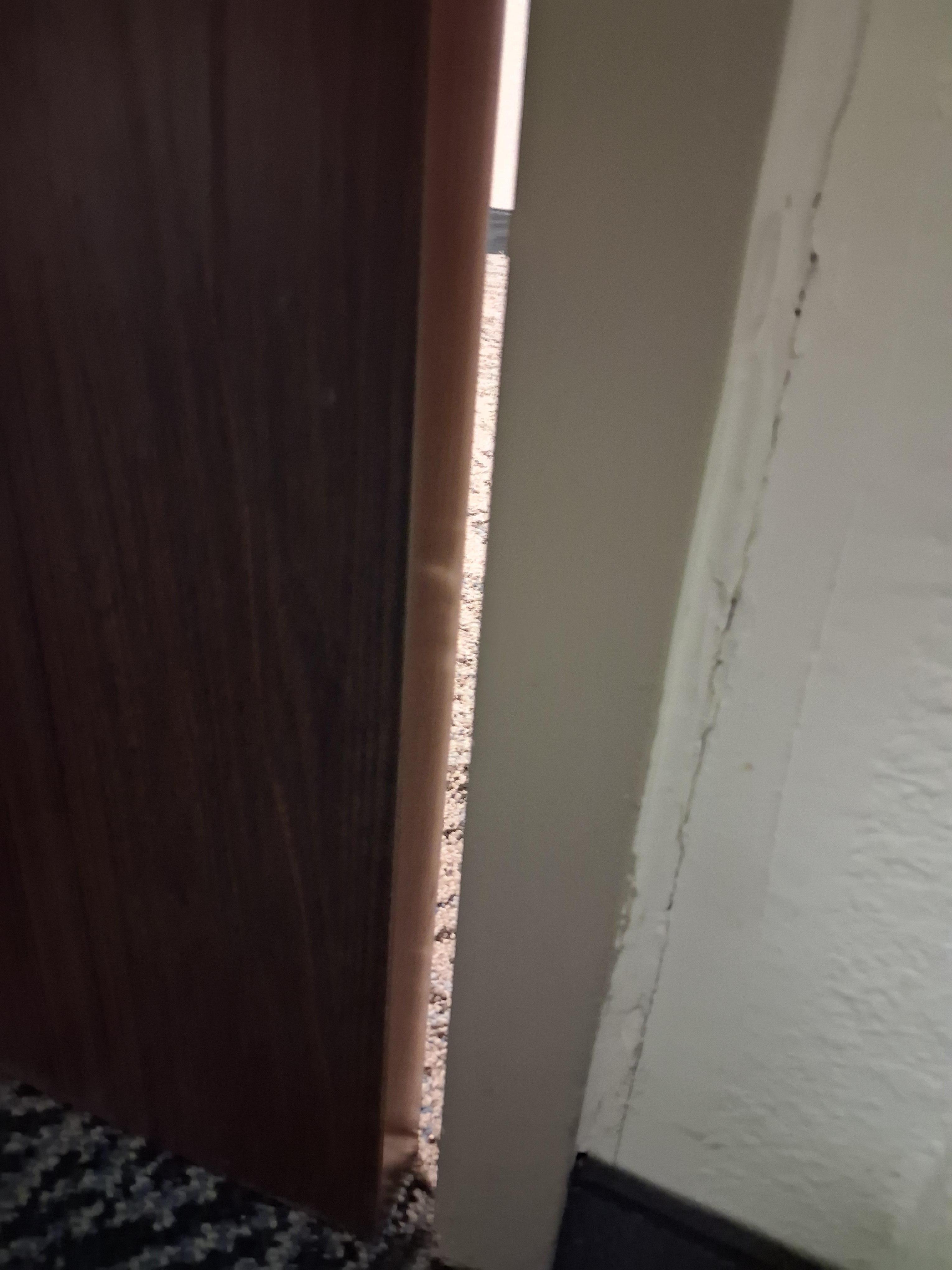 Door is locked and there is this much of a gap between the door and the doorframe.  