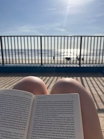 Reading on the pool deck overlooking the ocean