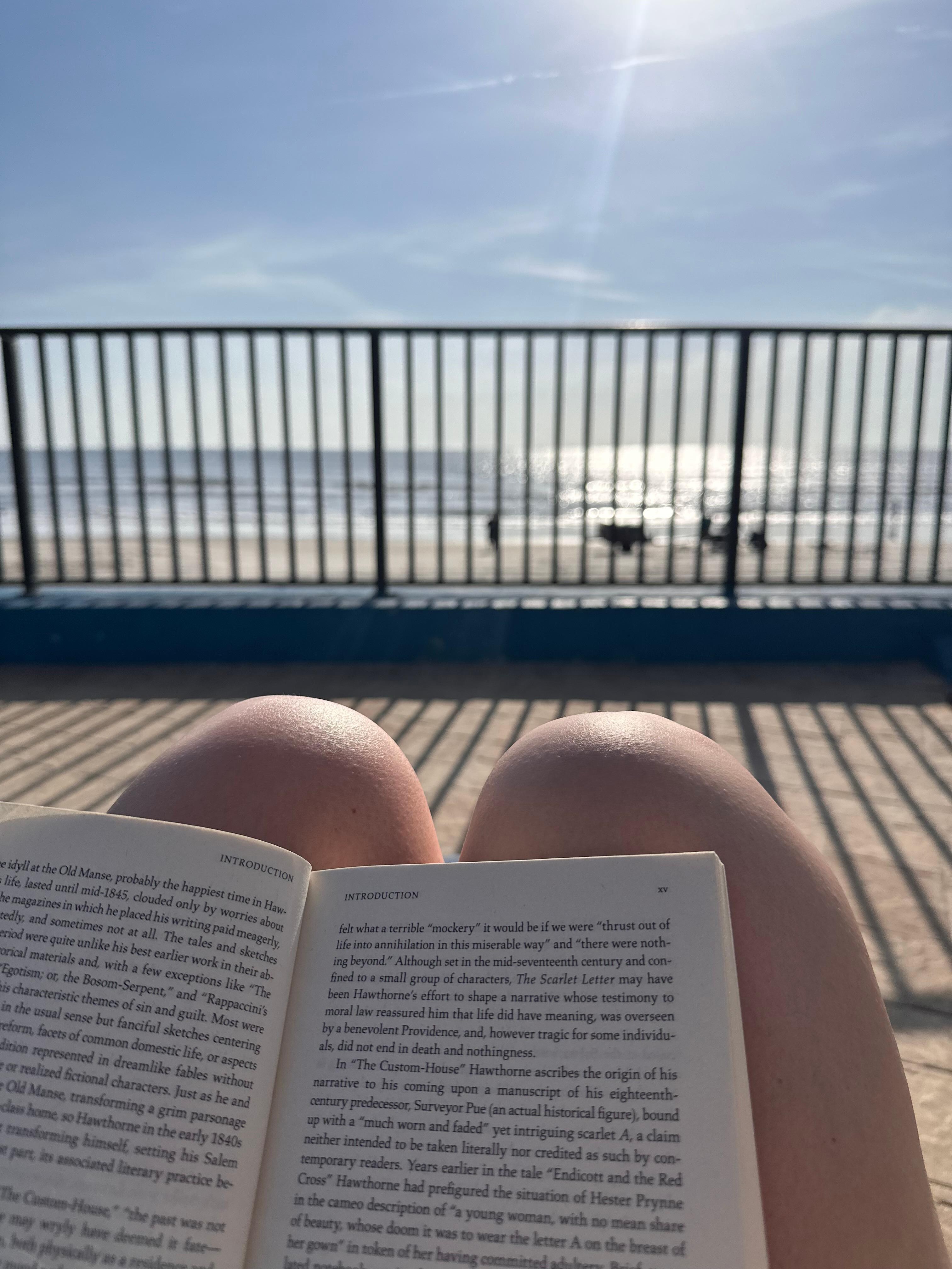 Reading on the pool deck overlooking the ocean