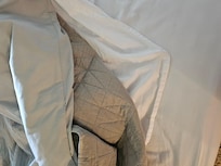 Other room had spread over sheet and blanket.