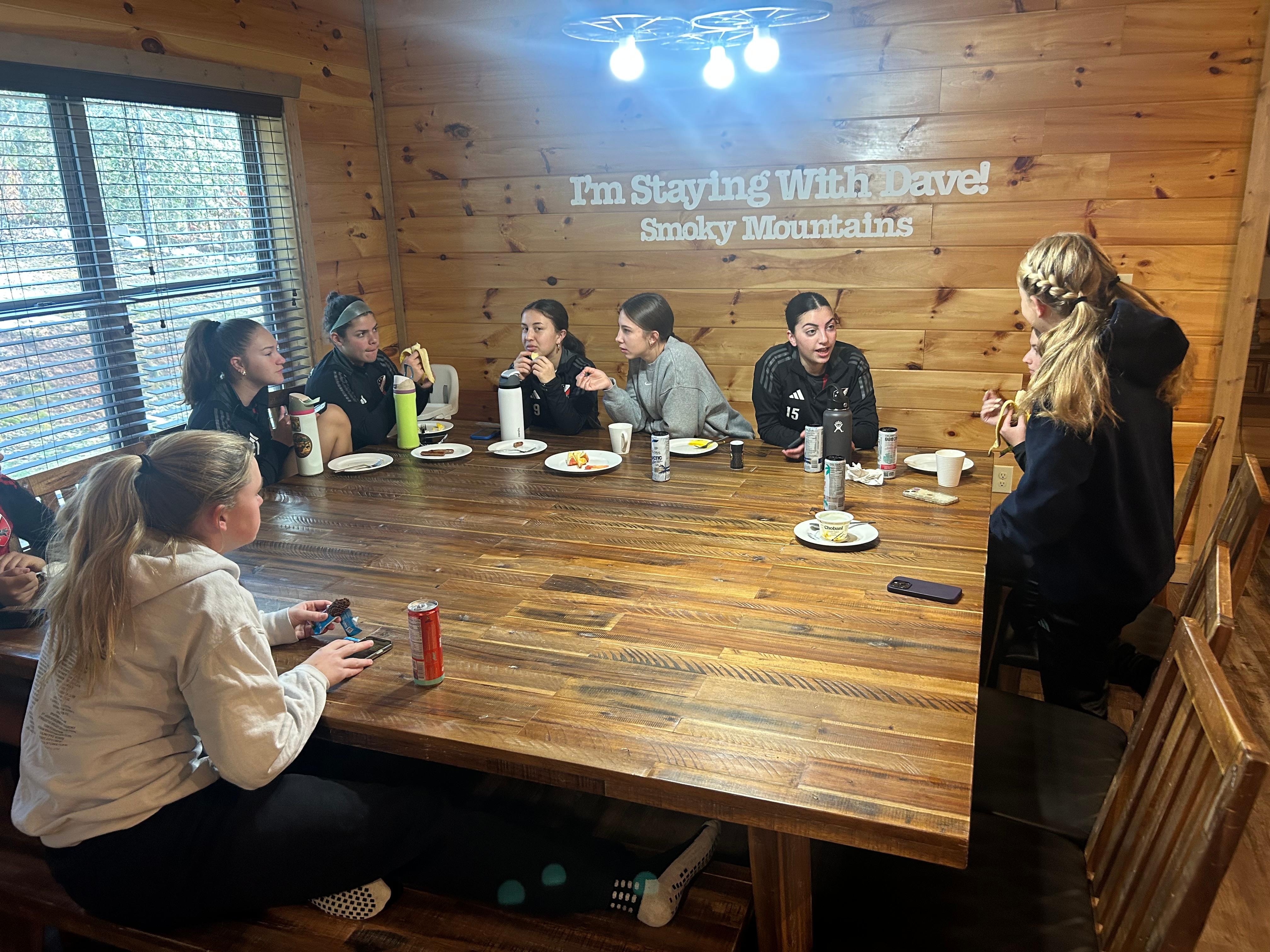 All the soccer girls having breakfast.