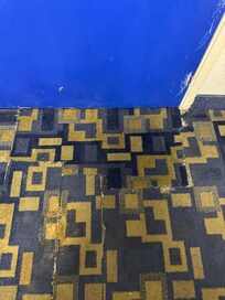 Places were carpet had been torn out in peace back together.