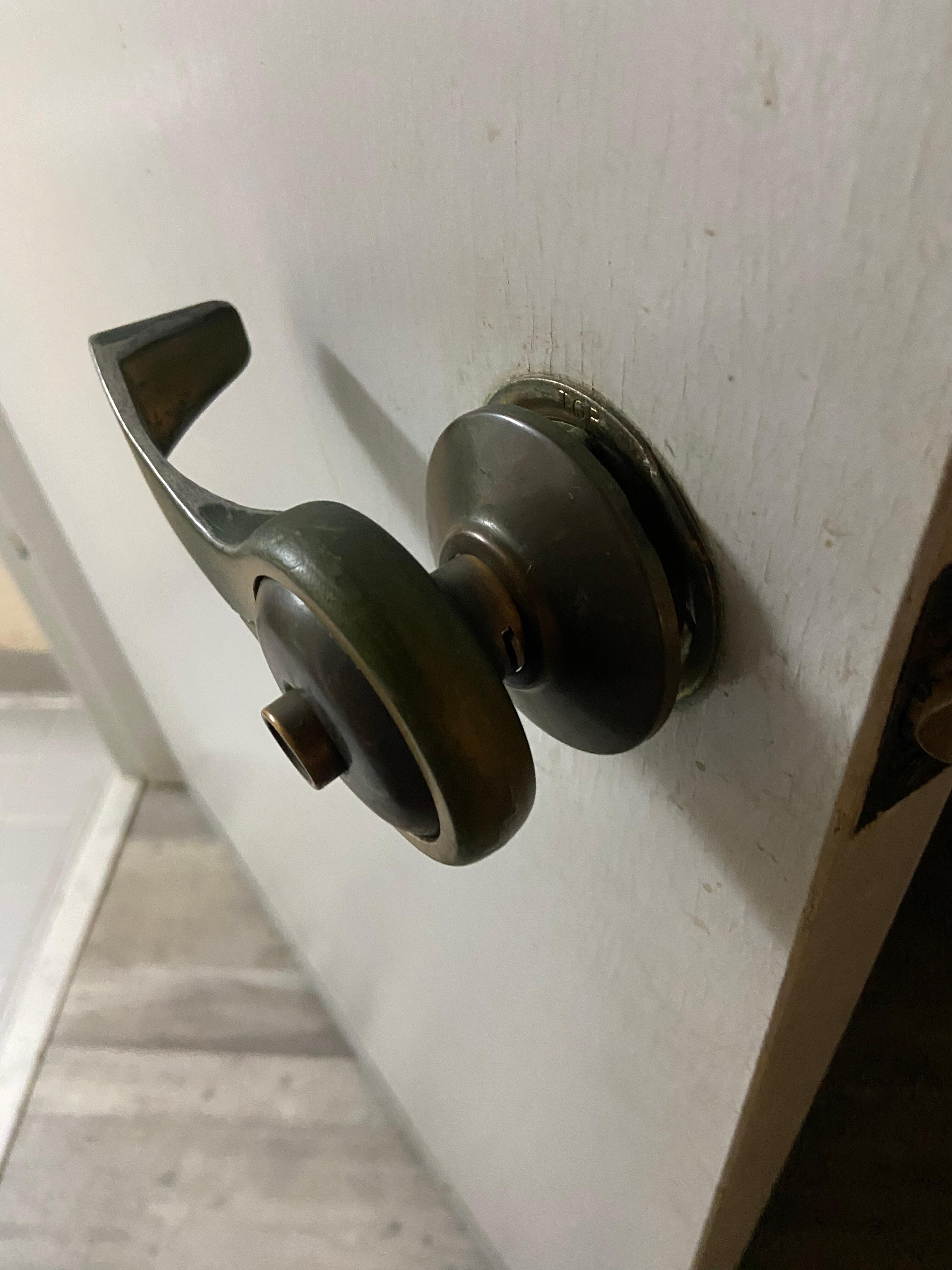 Loose bathroom door handle that was falling apart